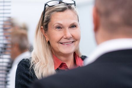 close up. elderly businesswoman talking to her colleague