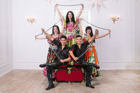 ensemble of folk Gypsy dance sitting on the big throne