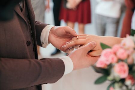 close up. bride and groom exchanging their wedding rings. holidays and eventsの写真素材