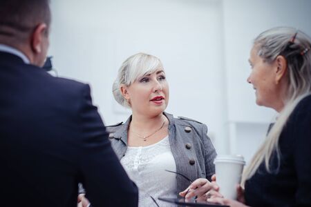 close up. businesswoman discussing something with her colleaguesの写真素材