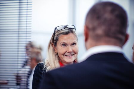 Elderly businesswoman talking to her colleagueの写真素材