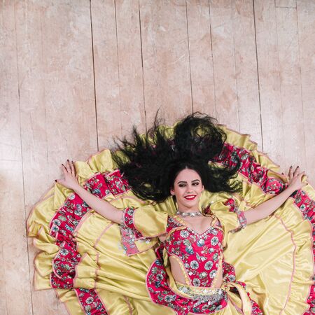 top view. smiling young woman performing passionate Gypsy dance.の写真素材