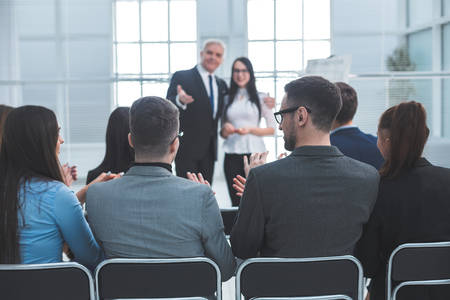 boss introducing a speaker at a business presentatioの写真素材