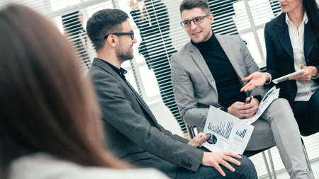 business colleagues discussing financial data in a conference room