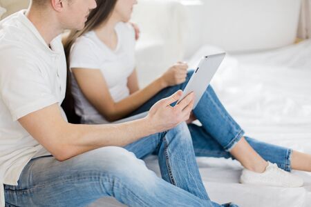 close up. a young family making orders in an online store for their new apartmentの写真素材