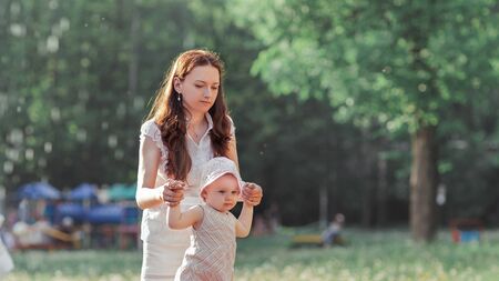 little girl standing near the city fountainの写真素材