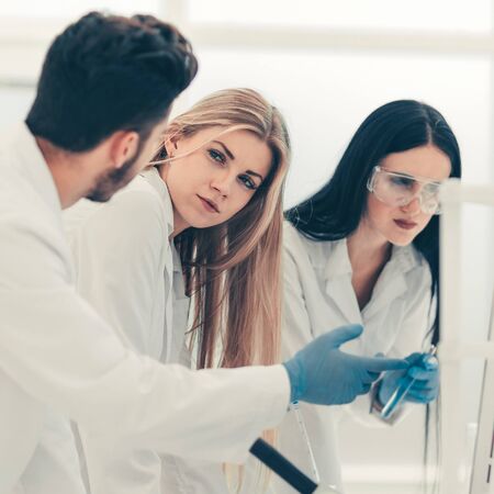 group of young scientist discussing research results