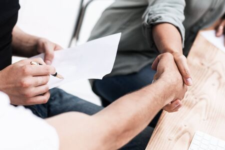 Close up handshake employee near the desktop.