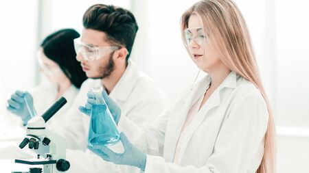 close up.young scientists are experimenting with liquidの写真素材