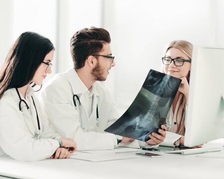 doctors experts discuss x-ray,sitting at the table