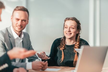 smiling young woman at a meeting with a working group.の写真素材