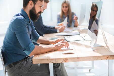 businessman uses a computer in the workplace in the office.の写真素材