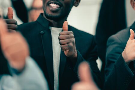 close up. young business people showing thumbs up.の写真素材