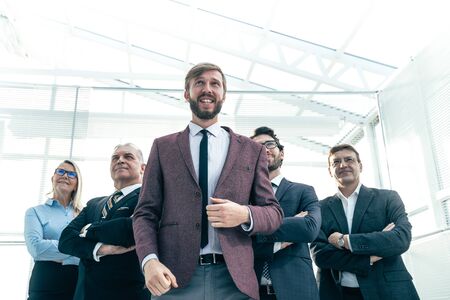 happy businessman with his business team standing in the office .