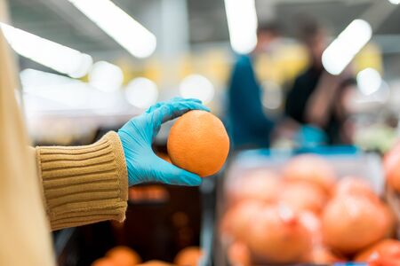 fresh orange in the hands of the buyer .security conceptの写真素材