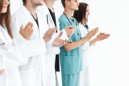 close up.a team of leading medics applauding togetherの写真素材