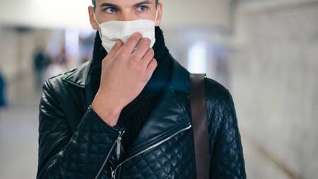 close up. a man in a protective mask standing in the subway crossing