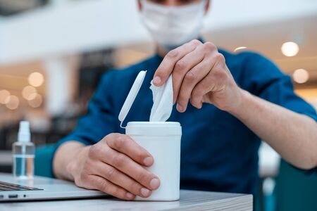 close up. young man takes out antiseptic wipesの写真素材