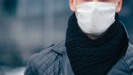 man in the protective mask is looking confidently aheadの写真素材