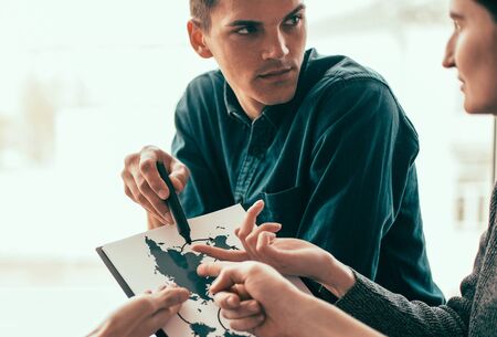 close up. young colleagues discussing new logistics schemes.の写真素材