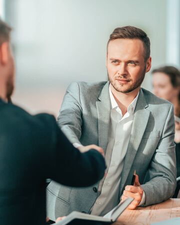 young businessmen confirm the deal with a handshakeの写真素材