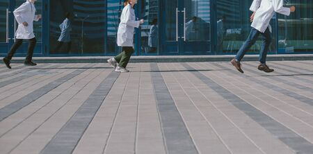 group of medical doctors rush to provide first aid .