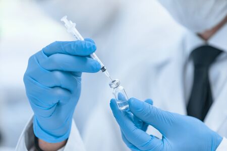 close up. scientist in protective gloves is testing a new vaccine . photo with copy - space.の写真素材