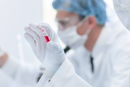 close up. virologist holds an ampoule with a new vaccine. photo with a copy-space.の写真素材