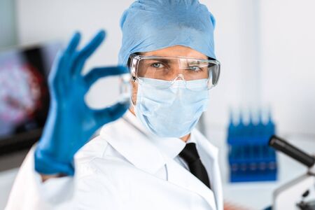 Scientist looking at a capsule with a new vaccine.