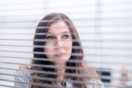 close up. Executive business woman standing near office window