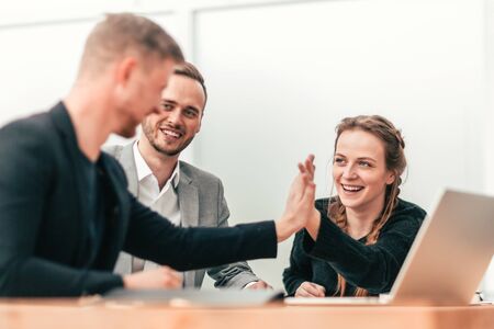 Confident business colleagues giving each other a high five