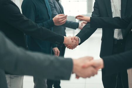 close up. a group of young entrepreneurs shaking hands with each other. concept of mutual assistanceの写真素材