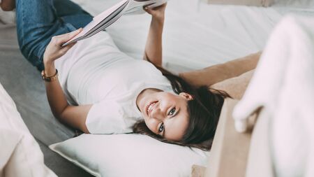 young woman with a project of her apartment lying on the floor.の写真素材