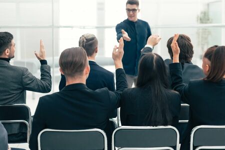 rear view. employees ask questions at a business briefingの写真素材