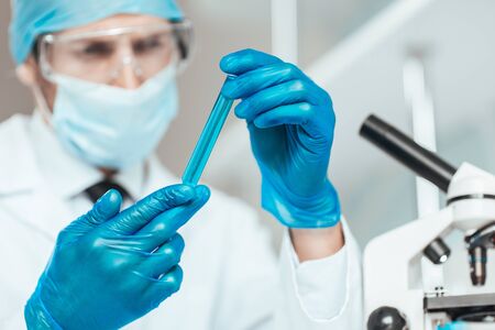 sample of the vaccine in the hands of the researcher .