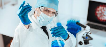close up. scientist studying the liquid in a medical flask.