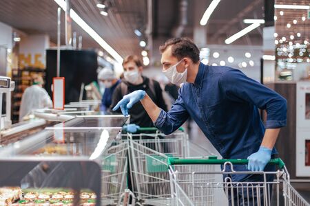 close up. young man choosing products in a supermarketの写真素材