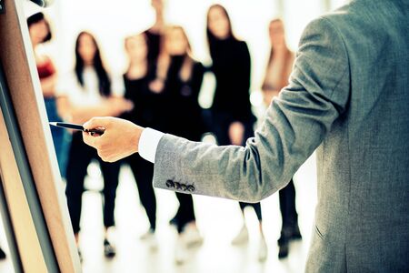 close up. businessman pointing with pen on a flipchartの写真素材