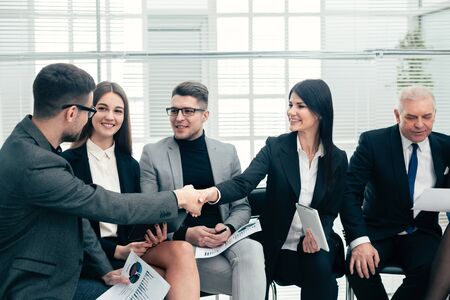 business colleagues greet each other in the conference room.