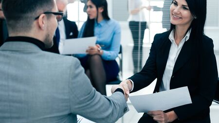 close up. businesswoman shaking hands with her business partner