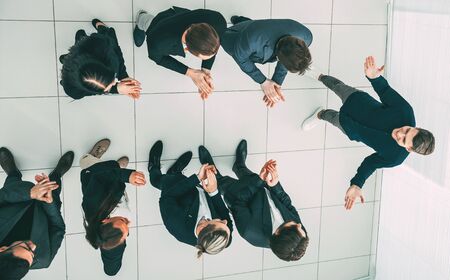 top view. business team applauding their comrade.の写真素材