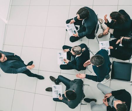 working group with financial documents sitting in the conference room.の写真素材