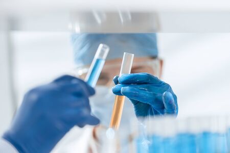 close up. scientists compare liquids in test tubes.