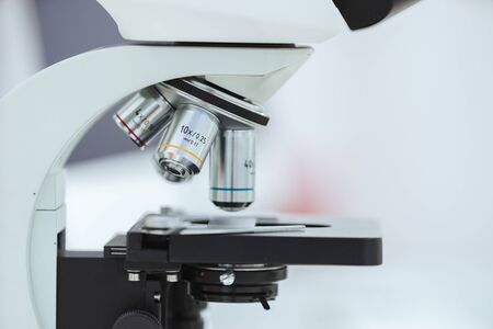 microscope with a sample on the table in the laboratory.