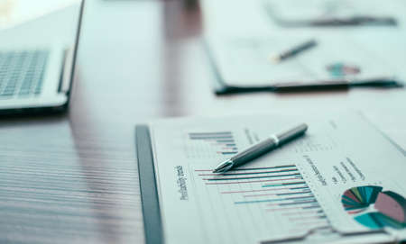close up. financial chart and pen on the desktop.