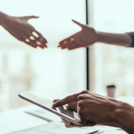 young woman using her smartphone at work in the office .の写真素材