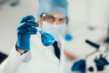 close up. medical flask in the hands of the researcher.の写真素材