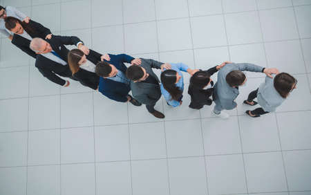 top view. a group of business people looking at their smartphon screens.