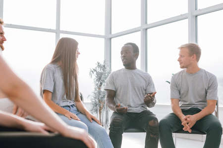 group of young people listening to the ideas of their friend.の写真素材
