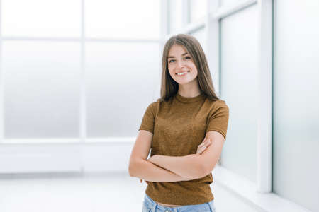 smiling young woman standing in bright office .